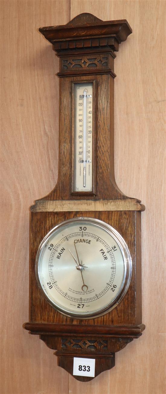 An early 20th century oak aneroid barometer and thermometer H.68cm